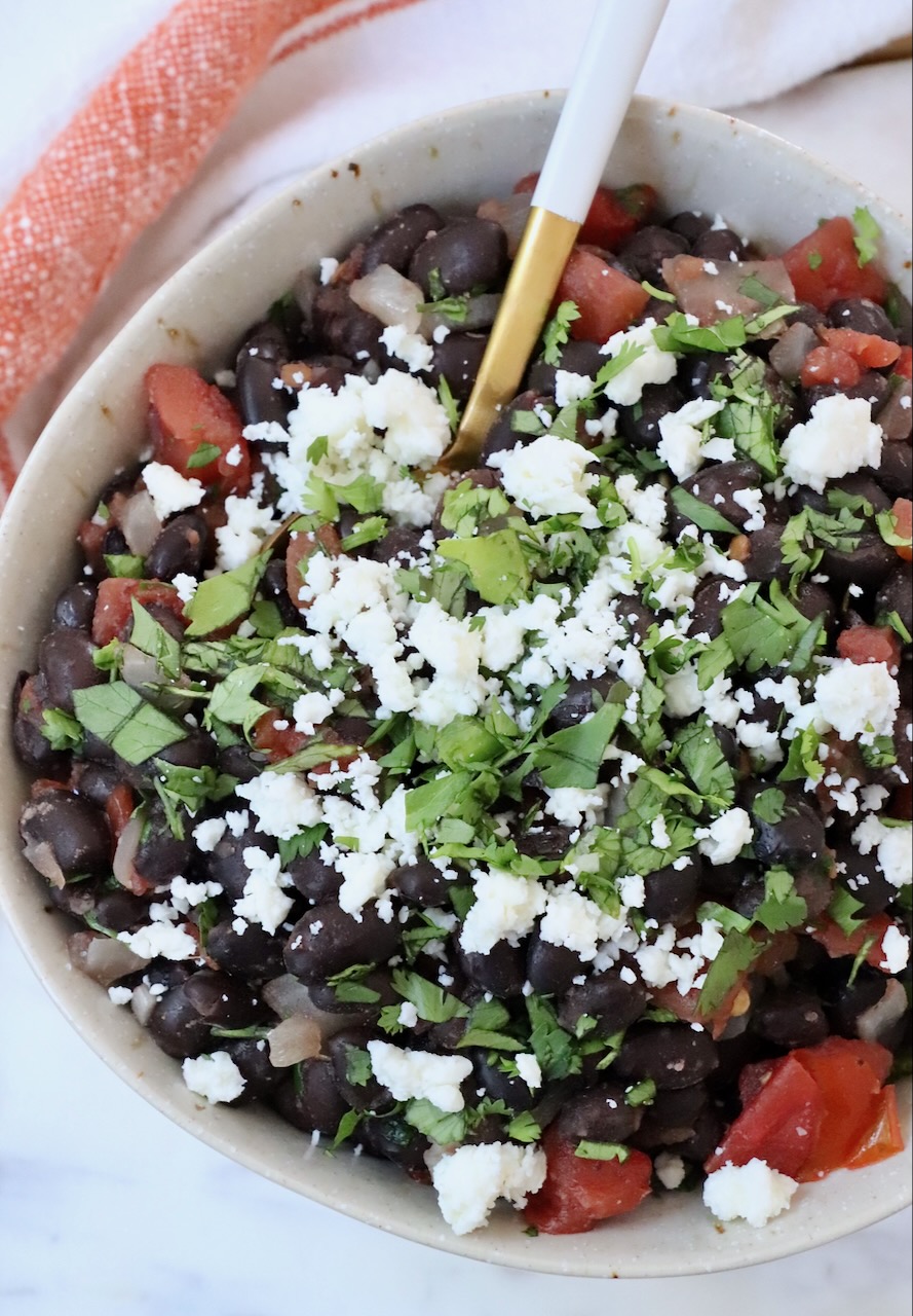 cooked black beans in bowl with spoon