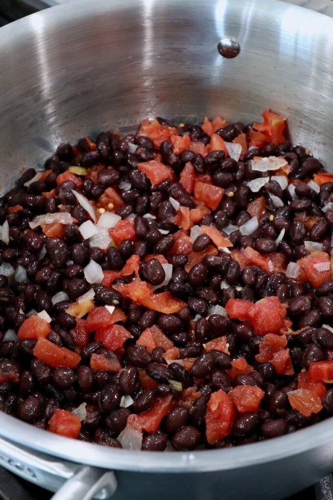 black beans, diced onions and tomatoes, in pot on the stove