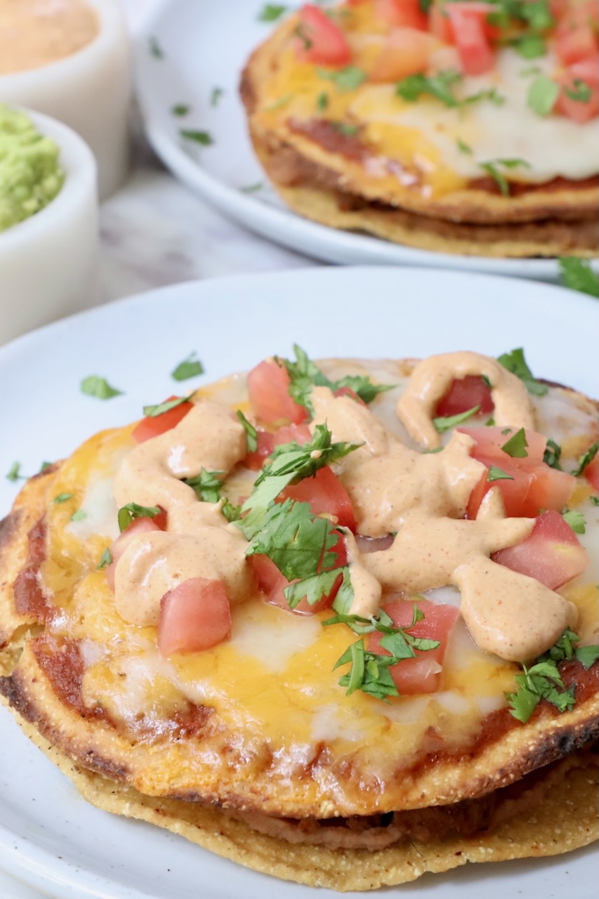 Mexican pizza topped with creamy jalapeno sauce on a plate