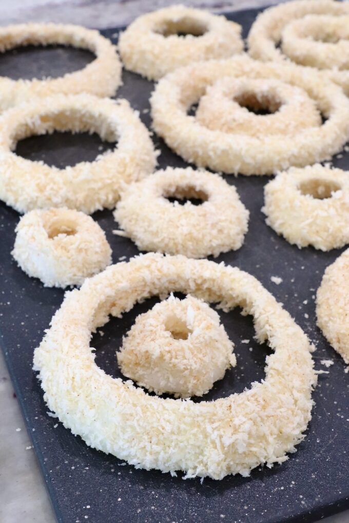 coated onion rings on cutting board