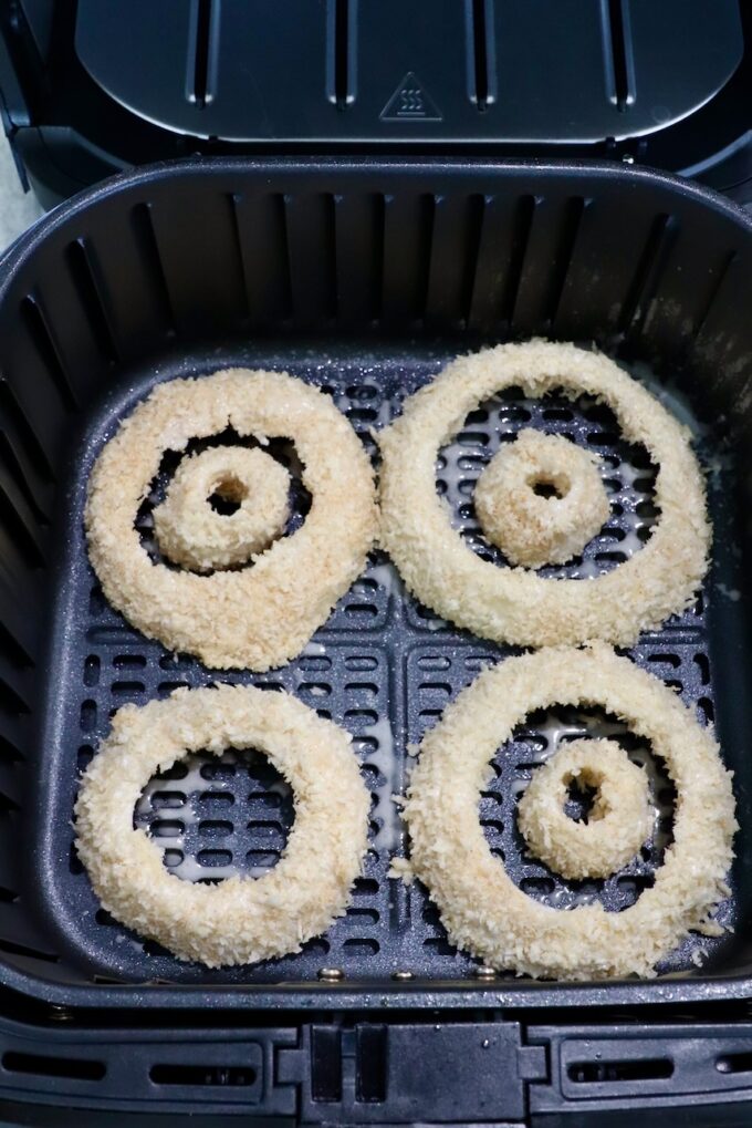 coated onion rings in air fryer basket