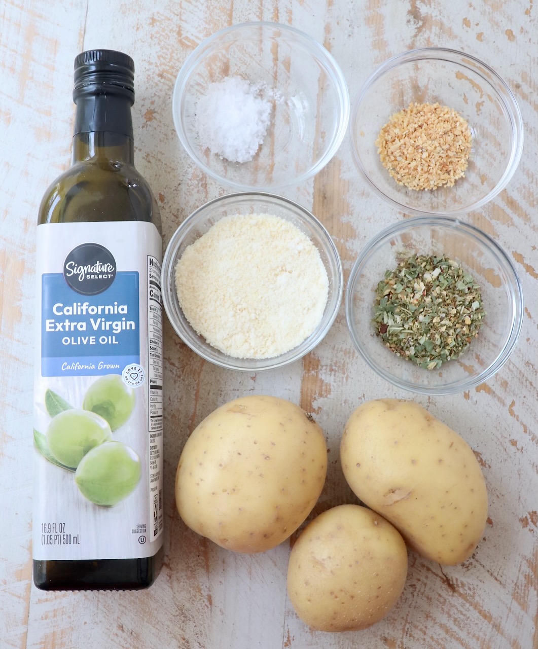 ingredients for air fryer roasted potatoes on white wood board