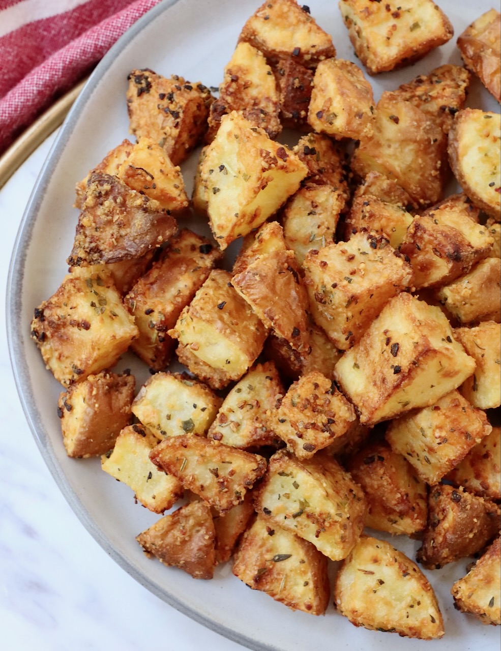 crisp roasted cubed potatoes on a plate