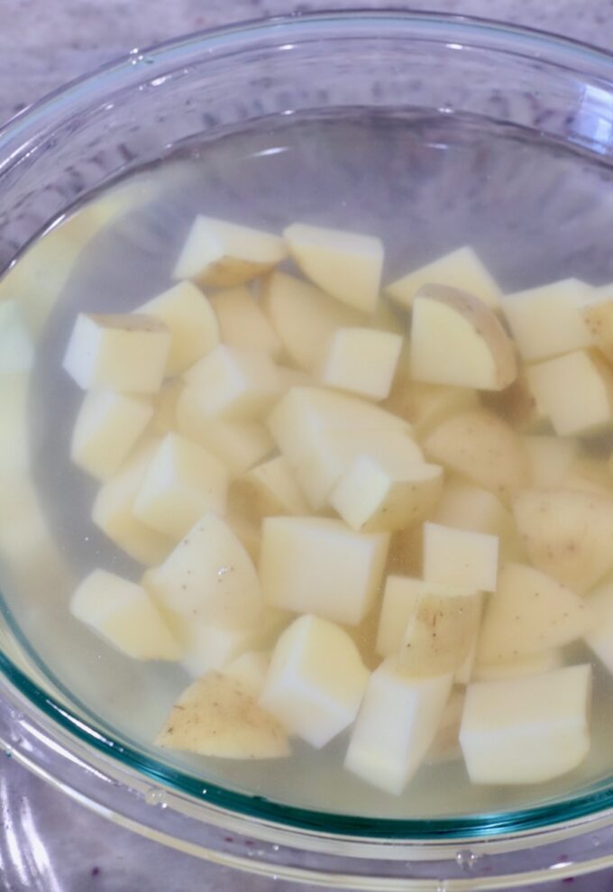 cubed potatoes in a bowl of water