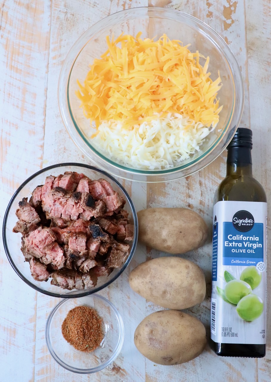 ingredients for carne asada fries on white wood board