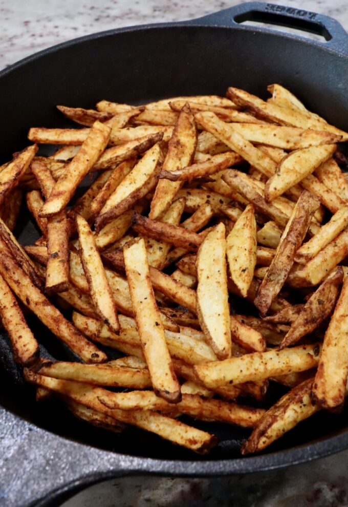 cooked french fries in cast iron skillet