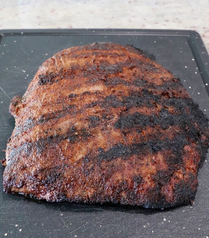 grilled flank steak on cutting board