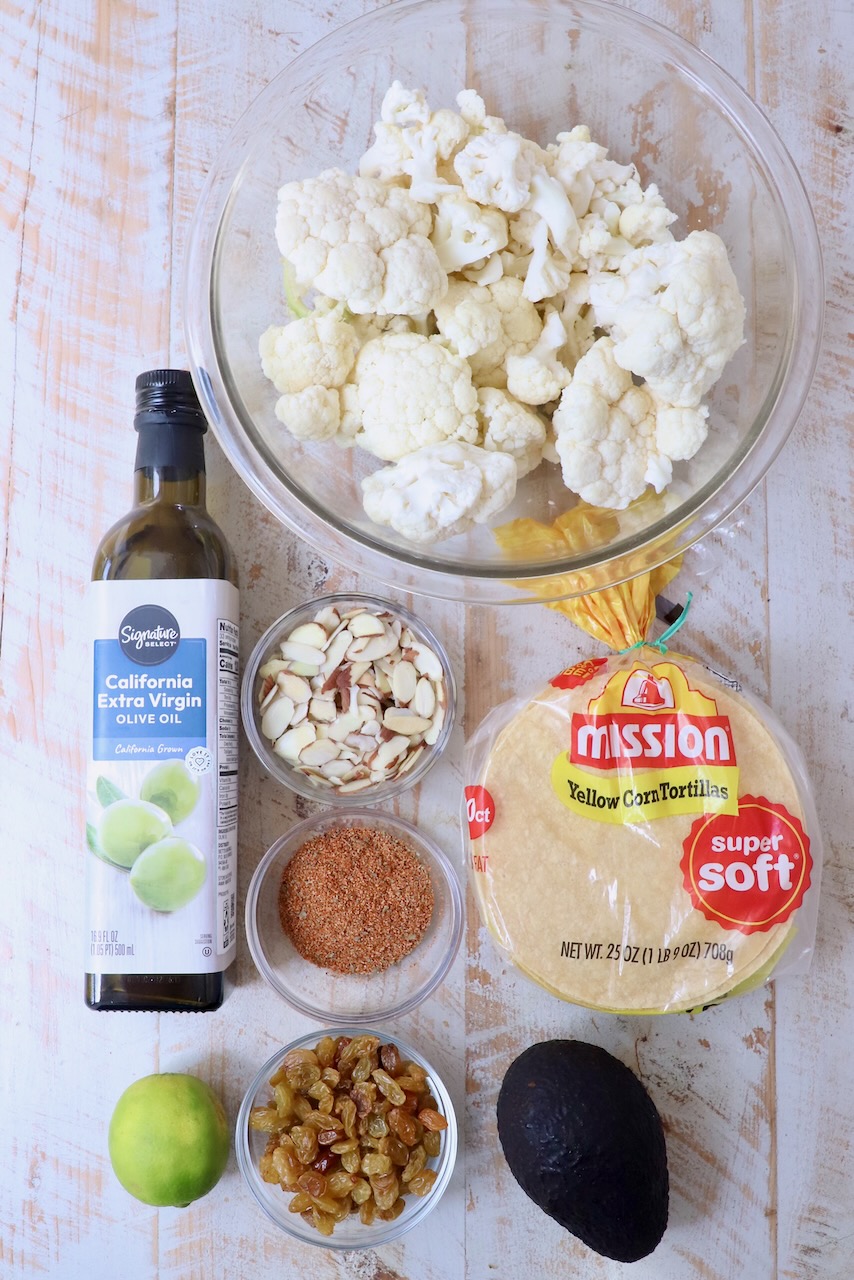 ingredients for cauliflower tacos on white wood board