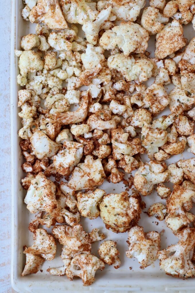 seasoned cauliflower florets on baking sheet