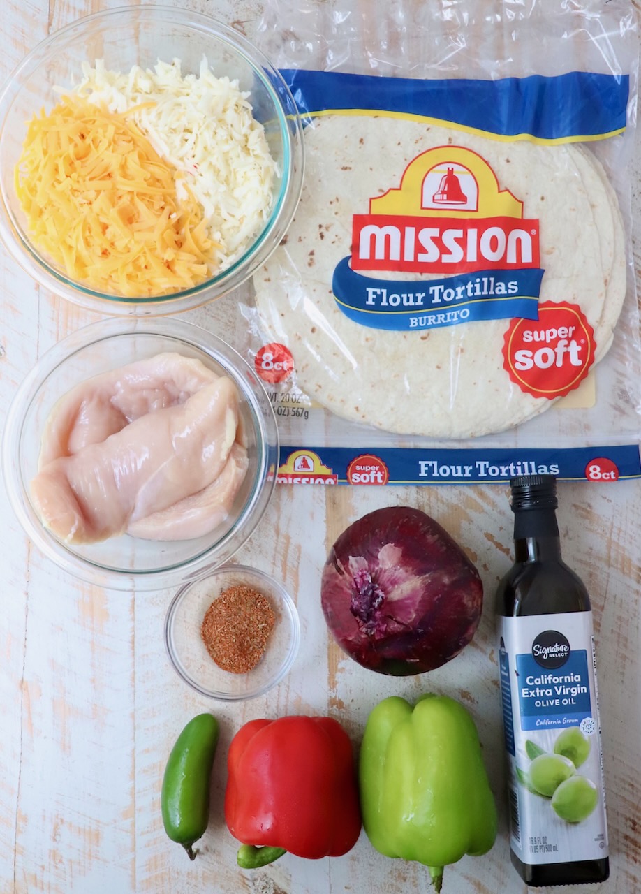 ingredients for chicken quesadillas on white wood board