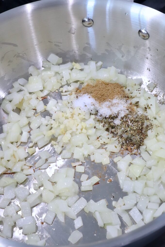 diced onions and garlic in pan with spices