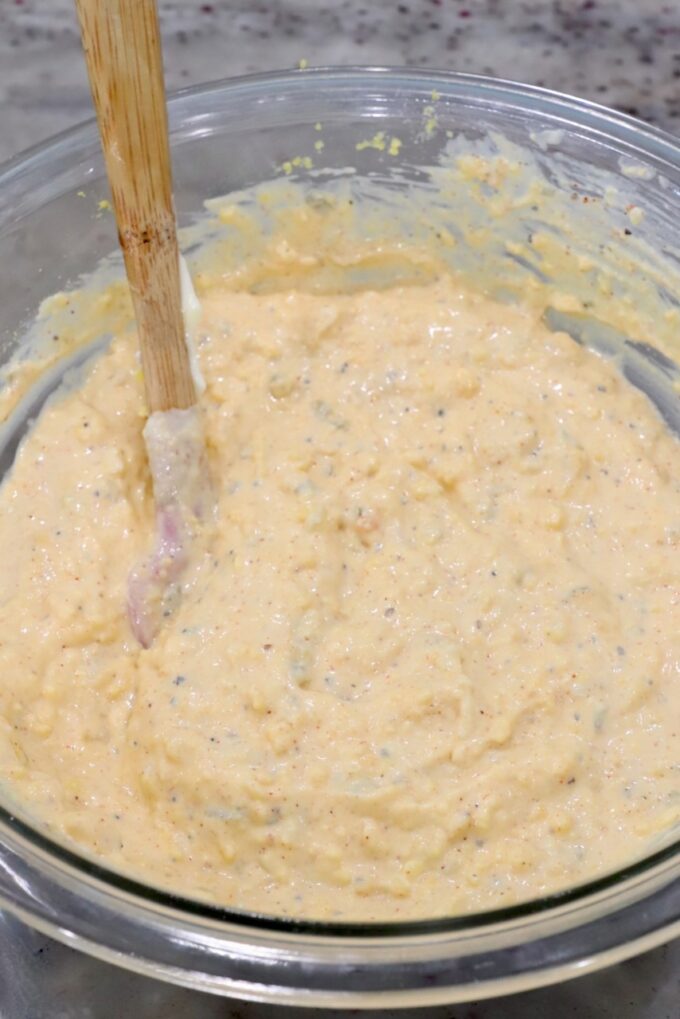 deviled egg pasta salad dressing in glass bowl with a spatula