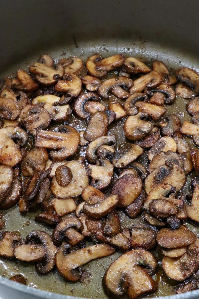 cooked sliced mushrooms in a large pot