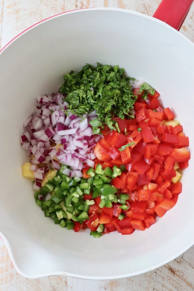 diced vegetables and pineapple in a large mixing bowl