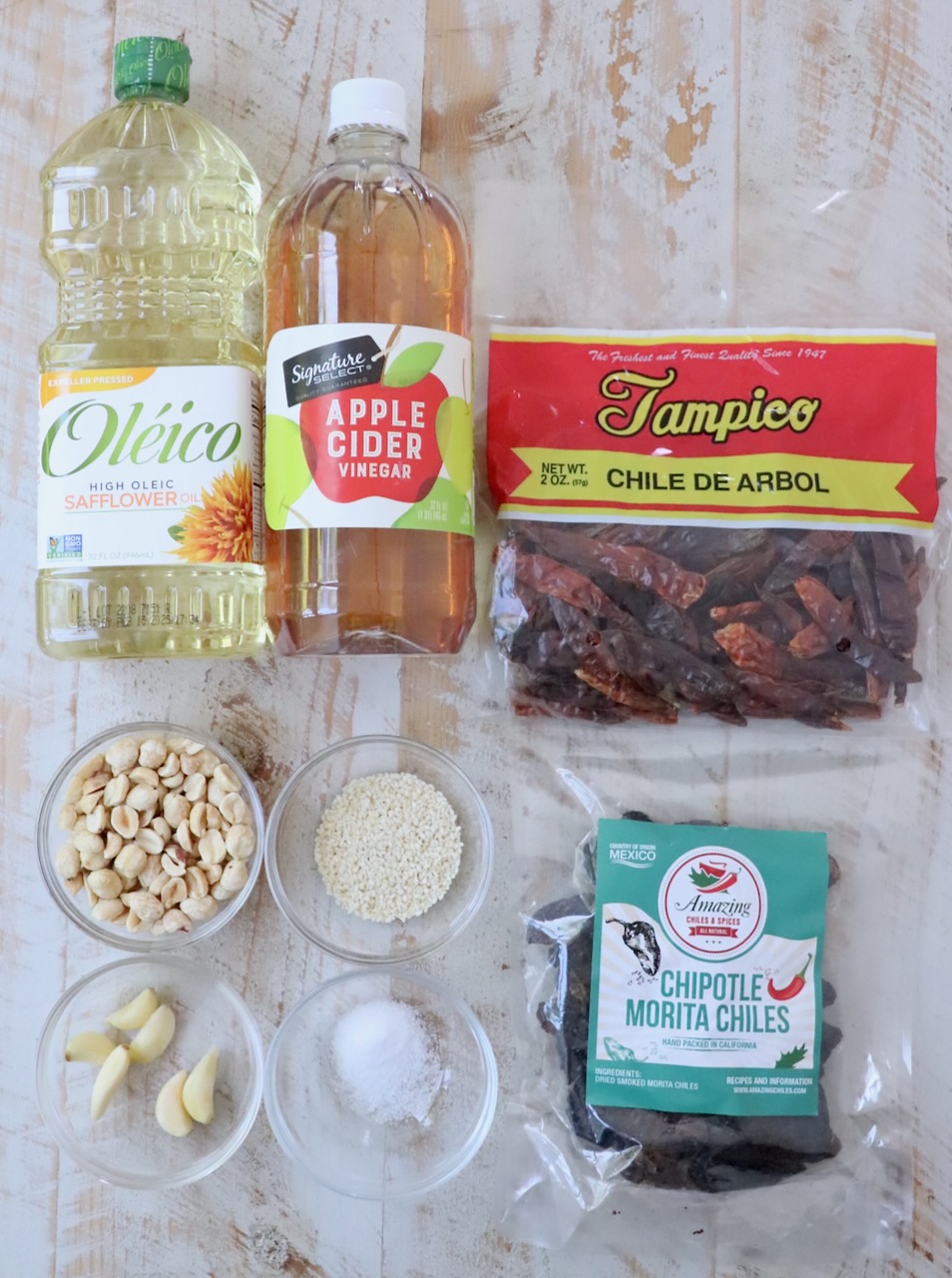 ingredients for salsa macha on a white wood board