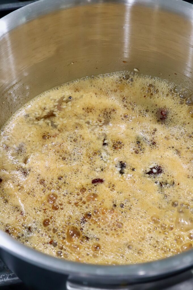 dried chiles, peanuts and garlic in oil in saucepan on the stove