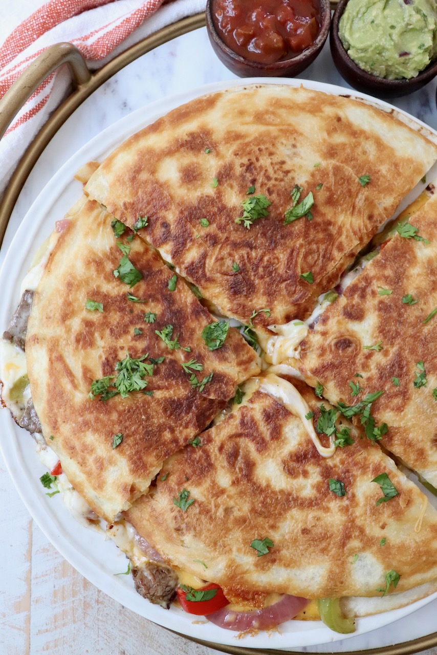 steak quesadilla on plate cut into four triangle pieces