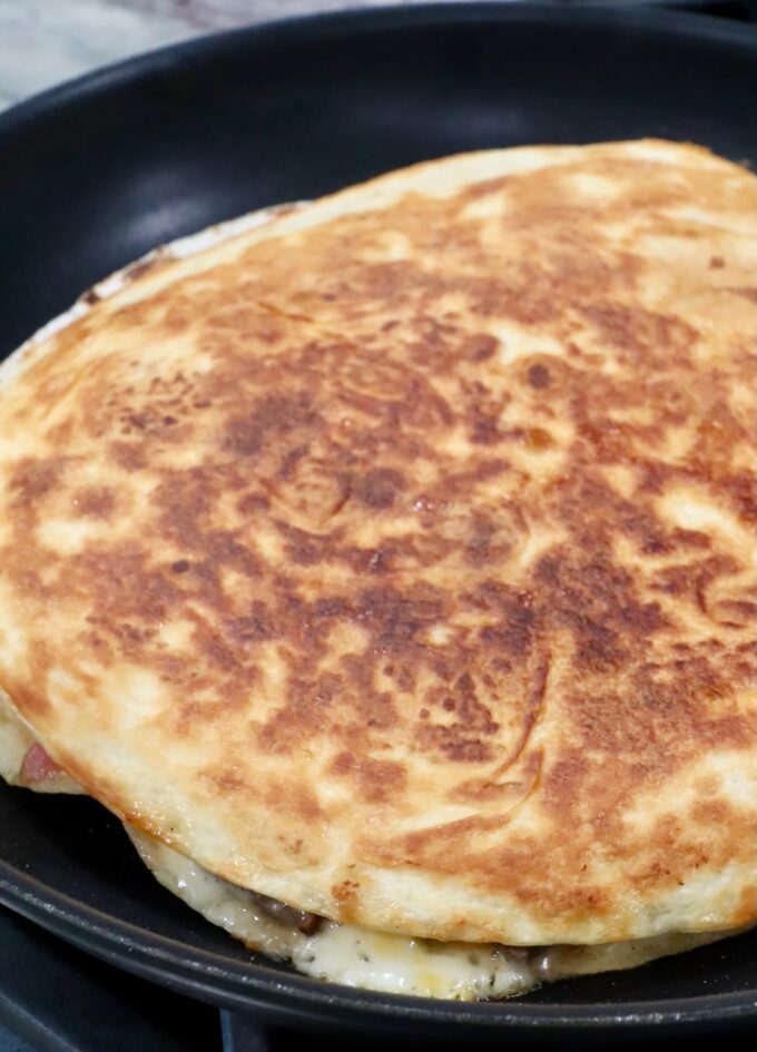 browned quesadilla in skillet