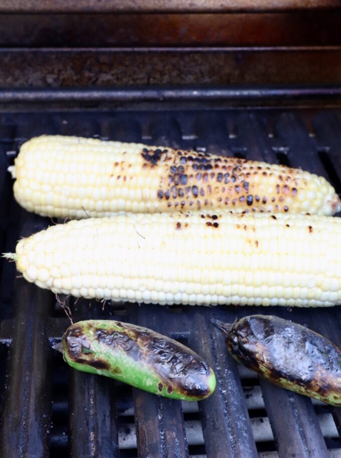 grilled corn on the cob and jalapenos on a grill