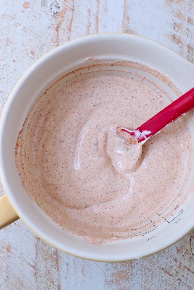 chili lime dressing in a mixing bowl with a spatula