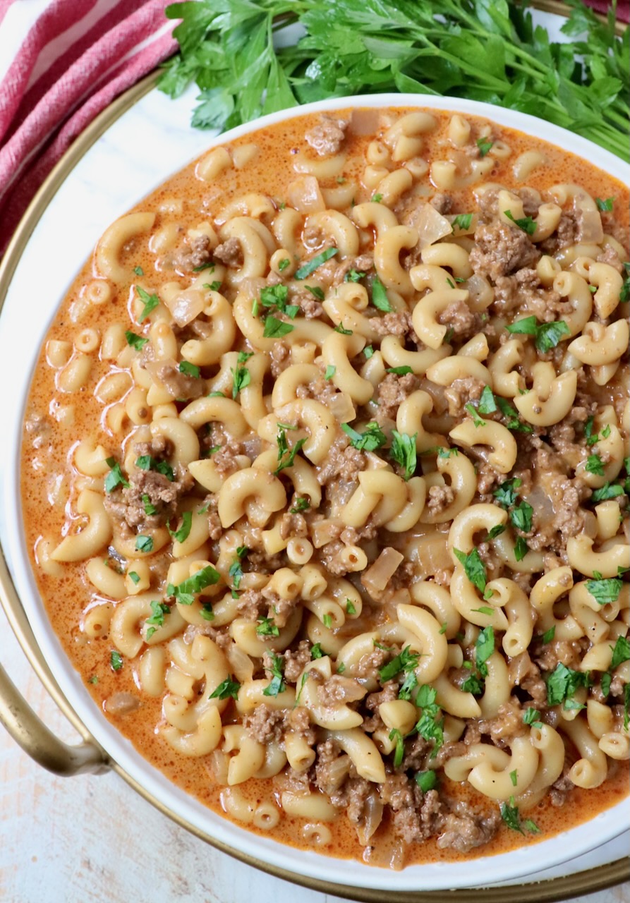 hamburger helper in bowl with fresh parsley on the side