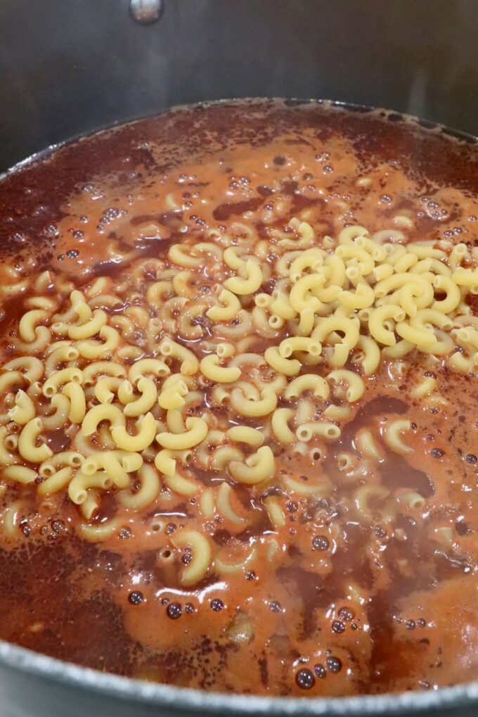 macaroni noodles in beef borth in a large pot