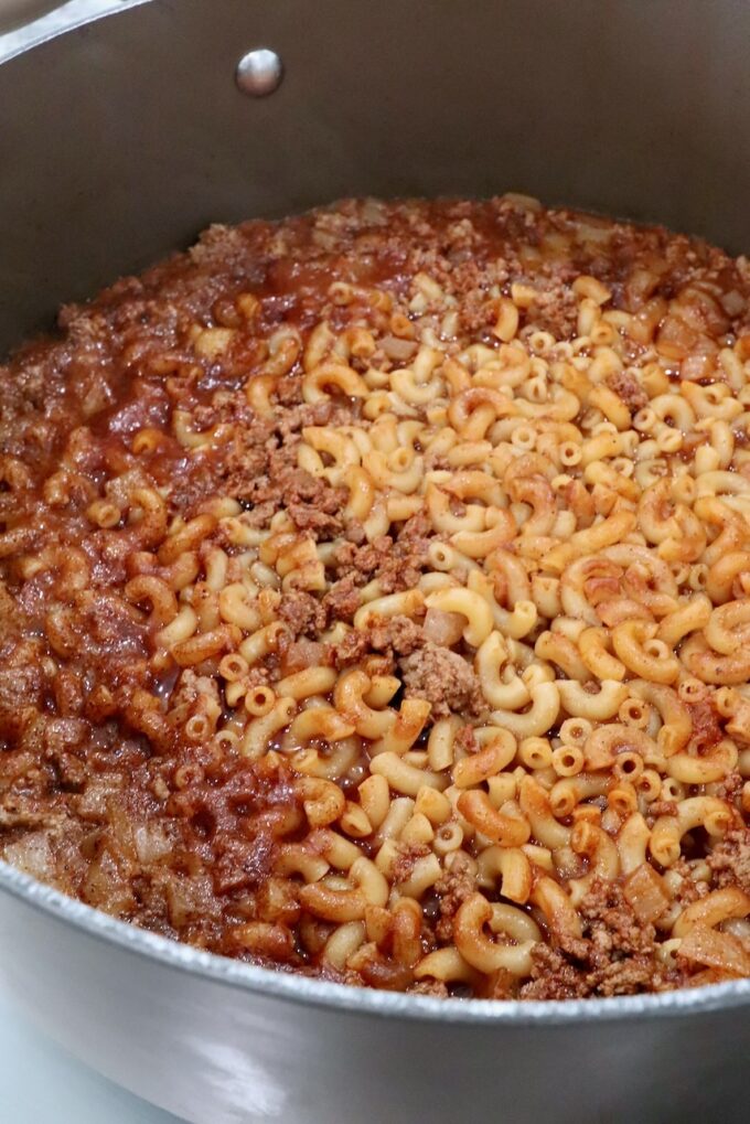 cooked macaroni noodles and ground beef in a sauce in a large pot