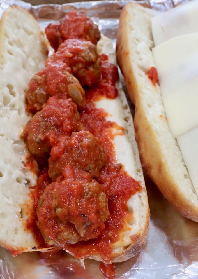 meatballs tossed in marinara sauce in a baguette with melted mozzarella cheese