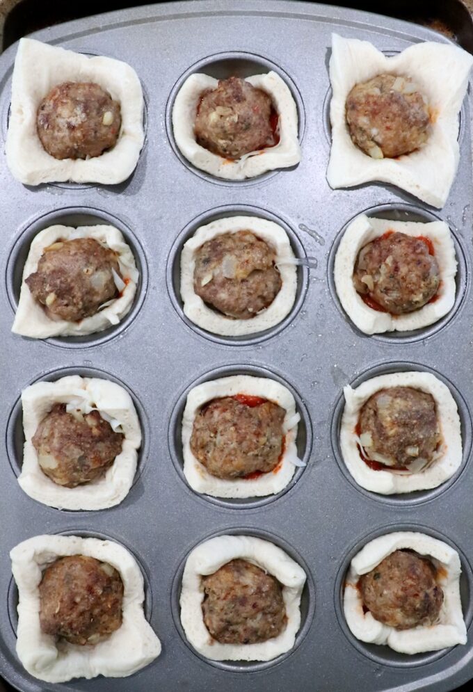 pizza dough squares pressed into a muffin tin and filled with meatballs