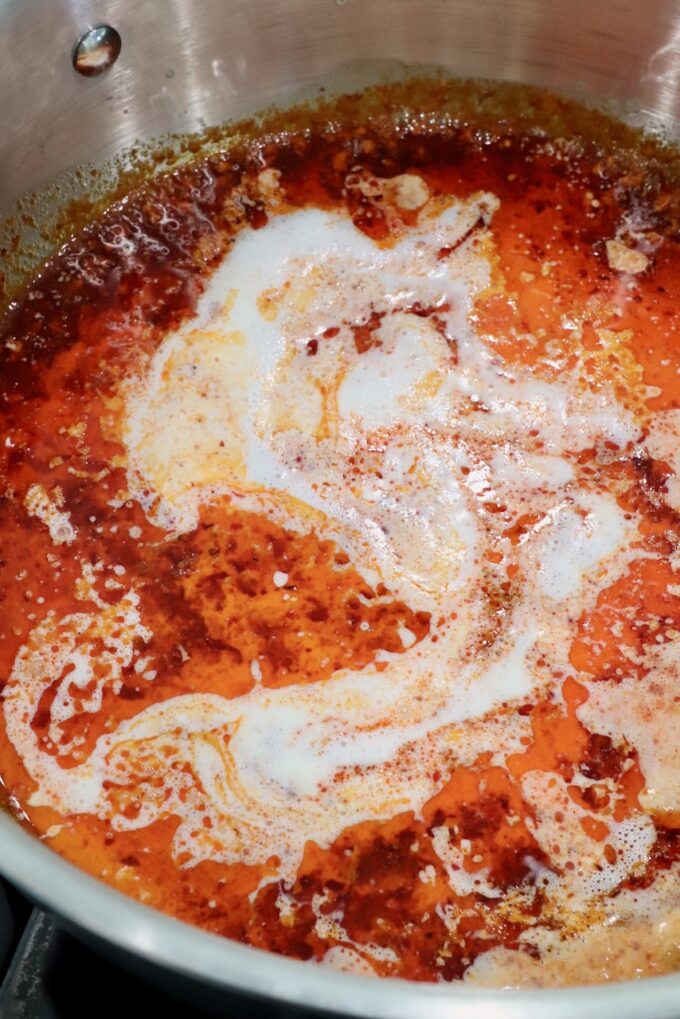 heavy cream in nduja sauce in a pan