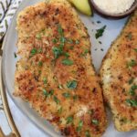 cooked parmesan crusted chicken on a plate