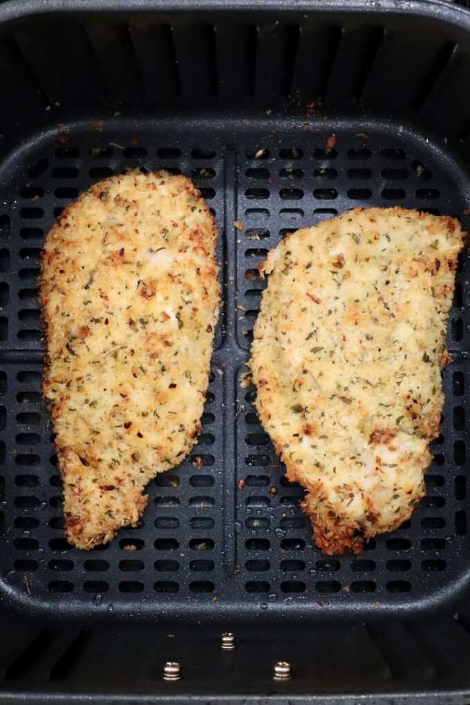 cooked breaded chicken breasts in an air fryer