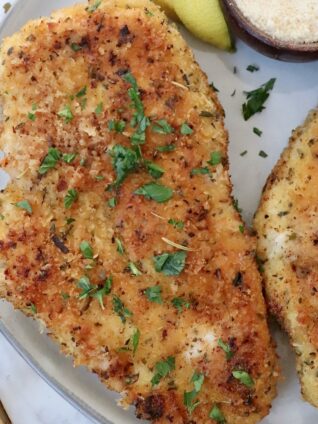 cooked parmesan crusted chicken on a plate