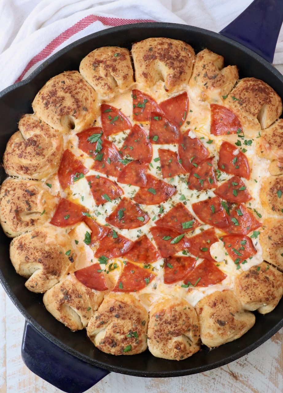 pizza dip surrounded by pull apart bread in a large skillet