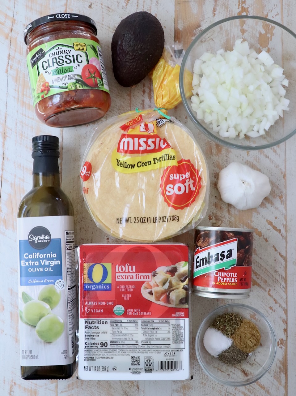 ingredients for tofu tacos on white wood board