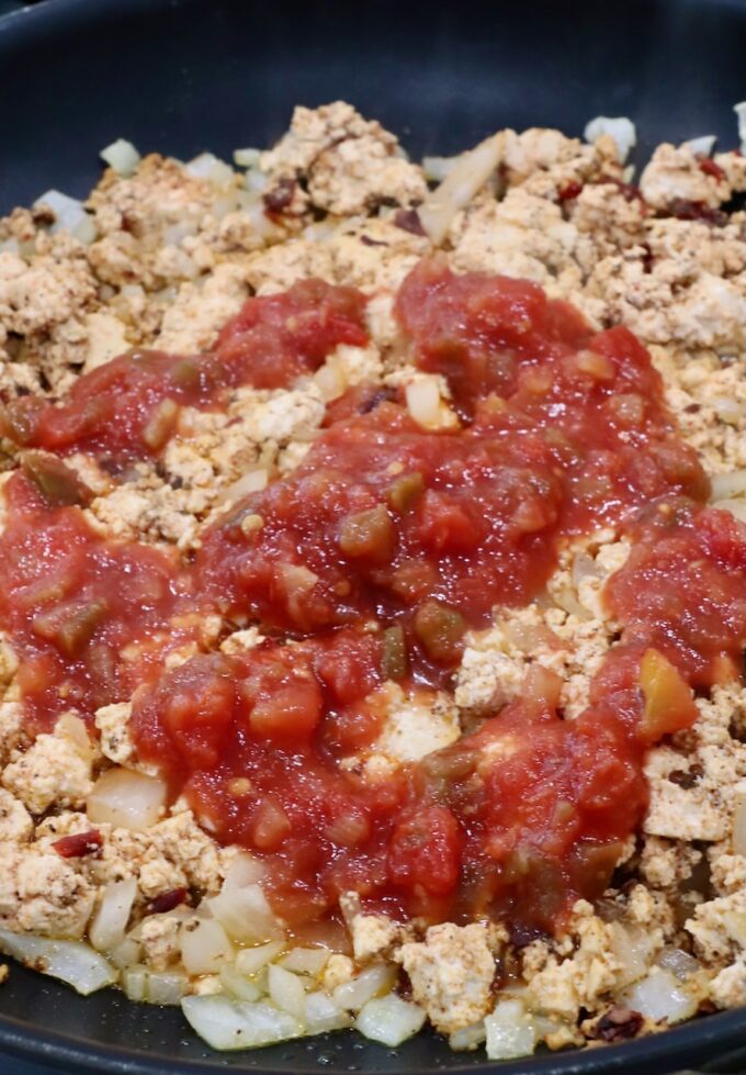 crumbled tofu topped with salsa in a skillet