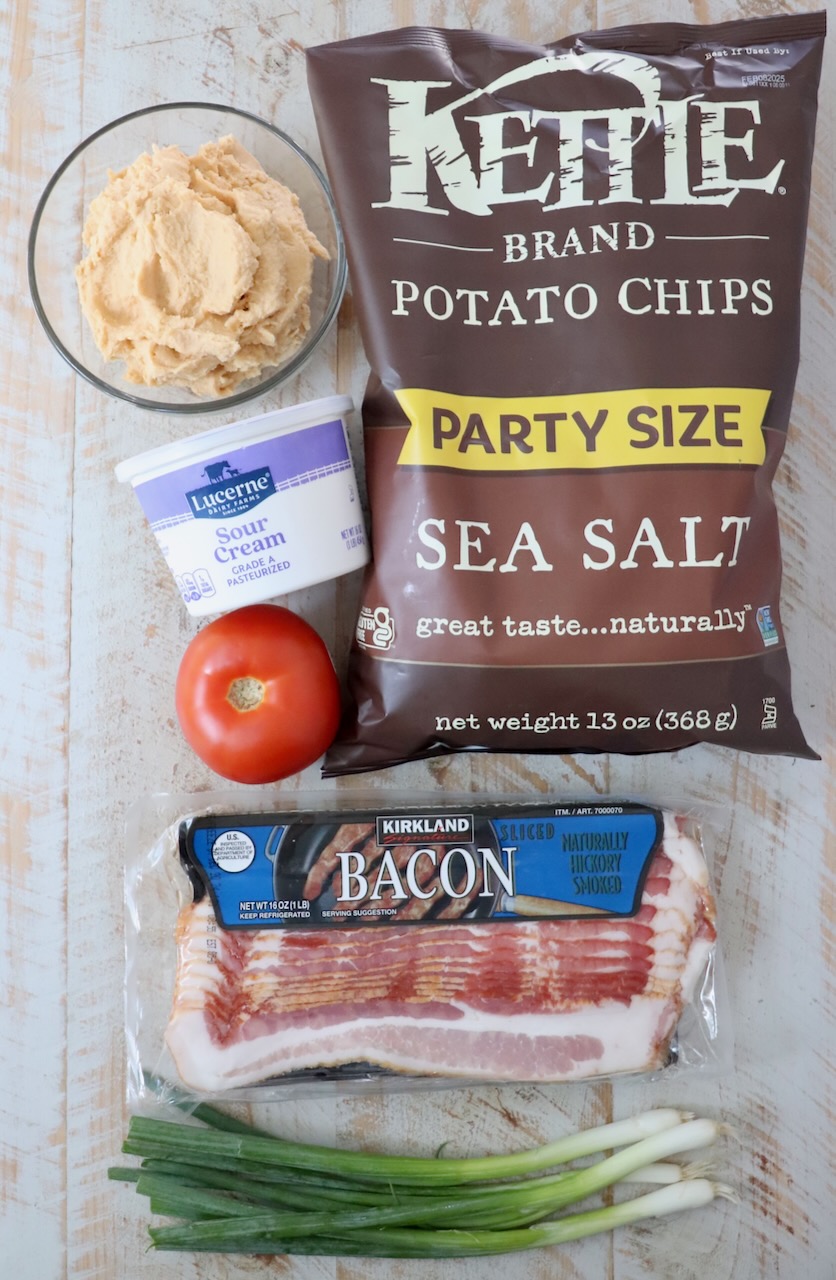 ingredients for Irish nachos on a white wood board