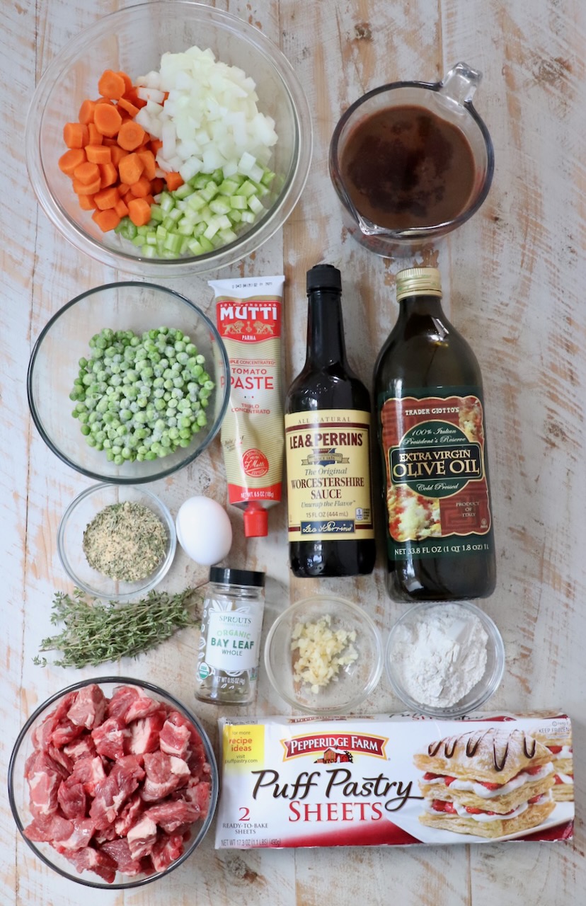 ingredients for beef pot pie on a white wood board