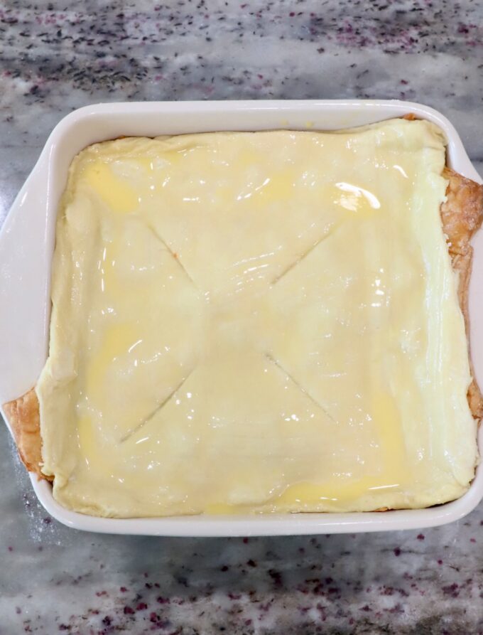 puff pastry dough brushed with egg wash in a baking dish