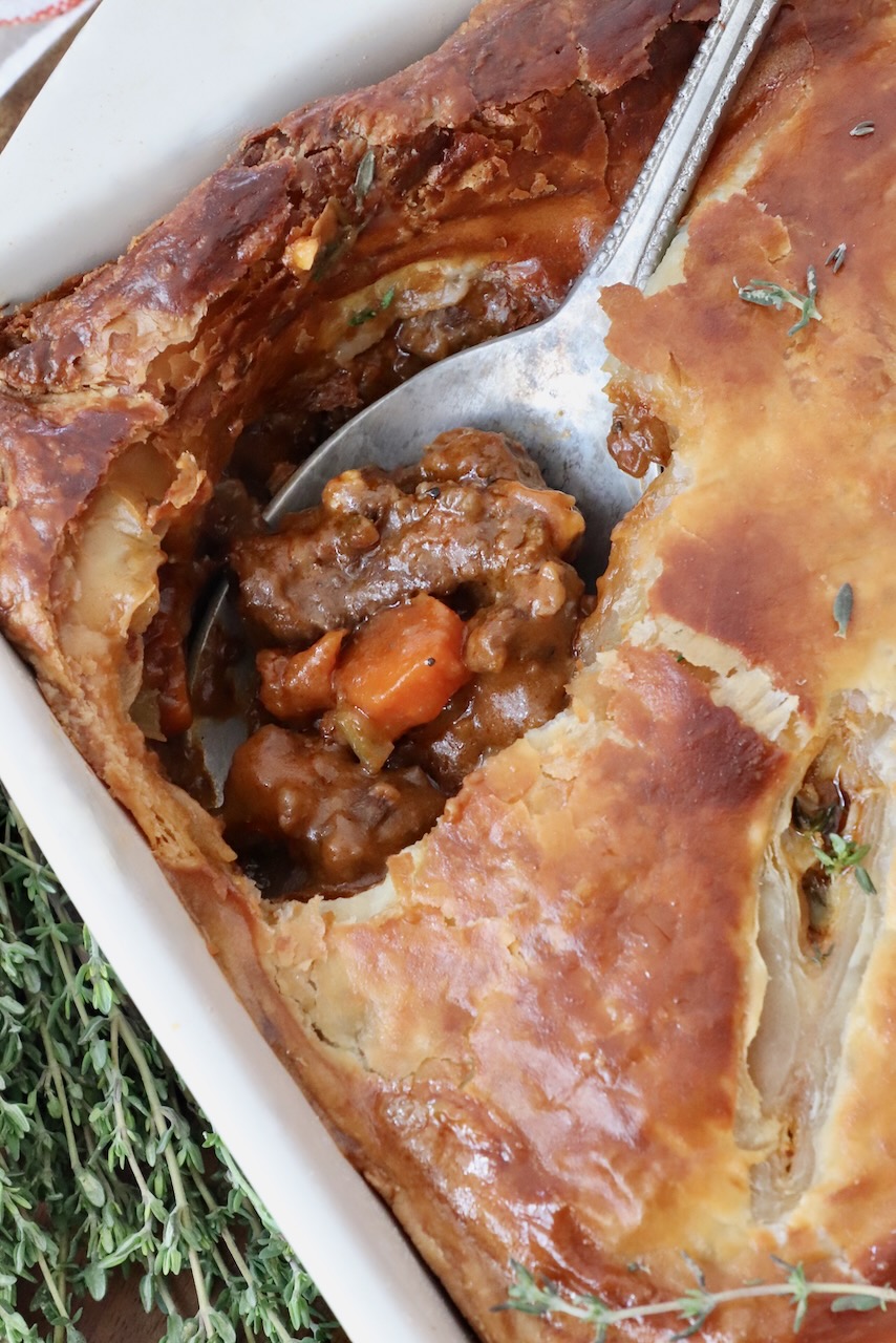 serving spoon in a baked beef pot pie