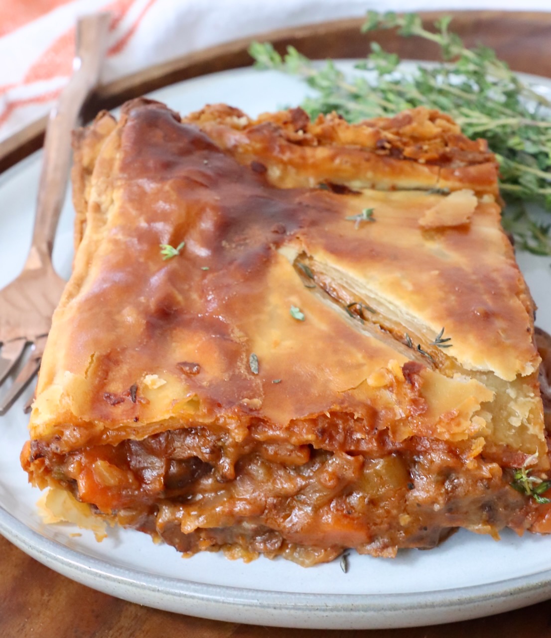 piece of beef pot pie on a plate with a fork