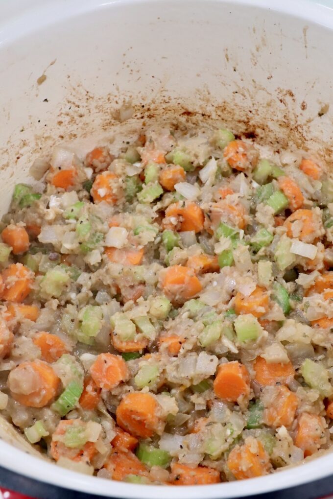 flour mixed with diced vegetables in a dutch oven