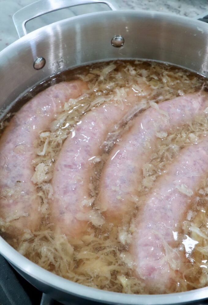 bratwurst in pan with beer and sauerkraut