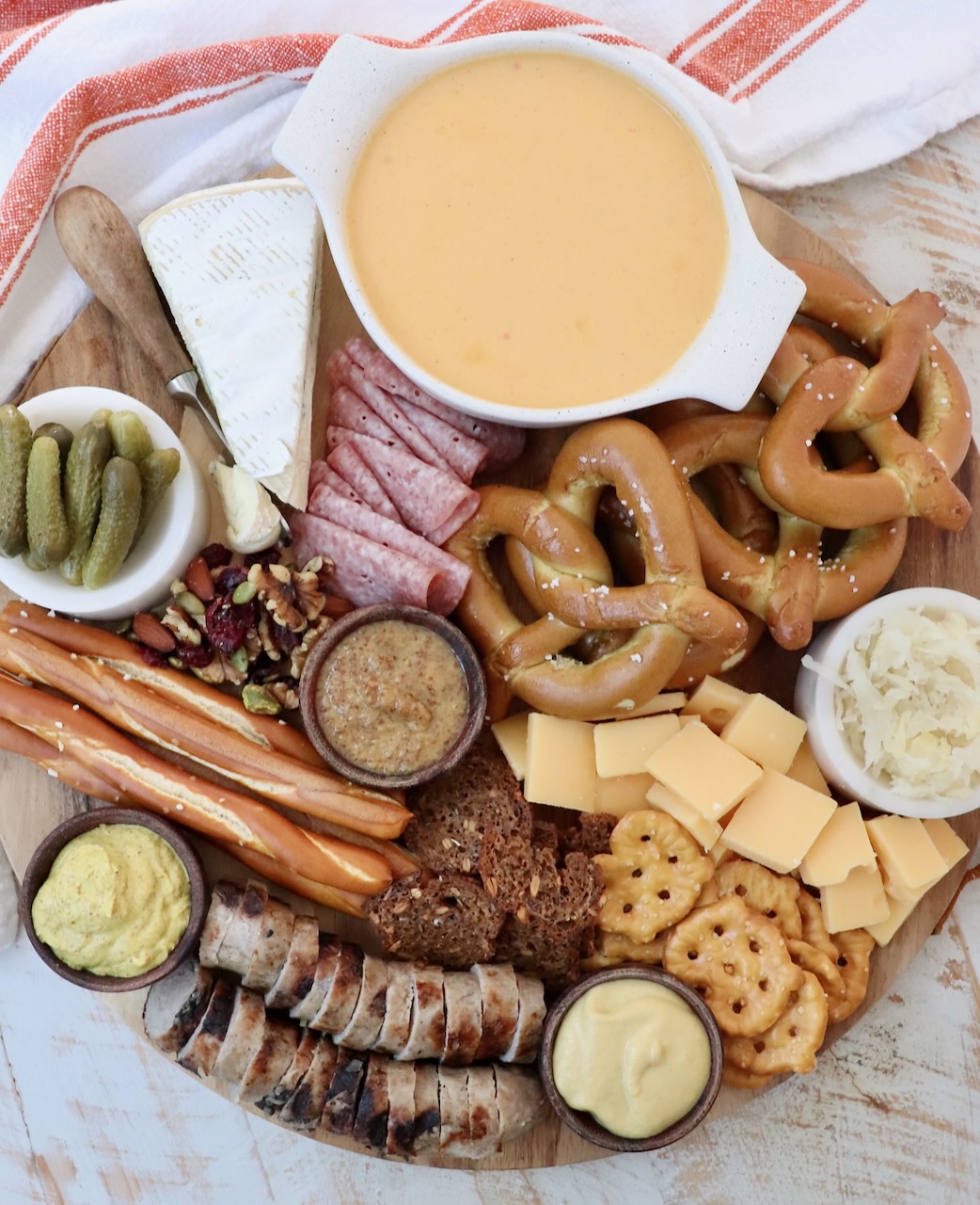 Oktoberfest charcuterie board filled with cheese, meats and pretzels