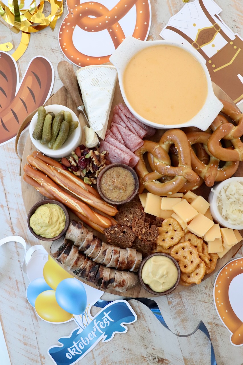 Oktoberfest charcuterie board surrounded by Oktoberfest decorations