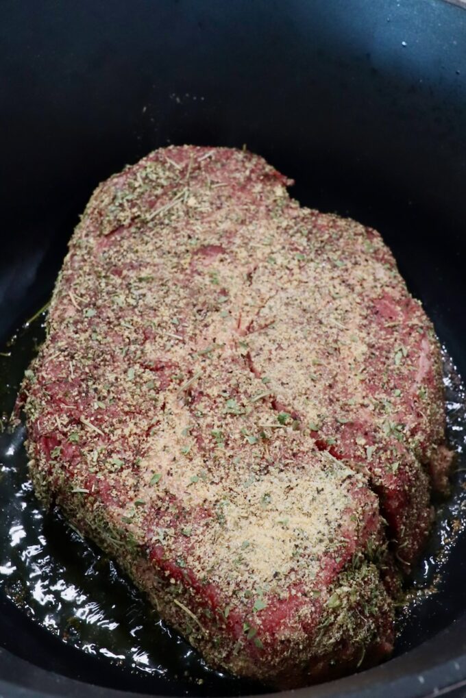 seasoned chuck roast in a large cast iron dutch oven