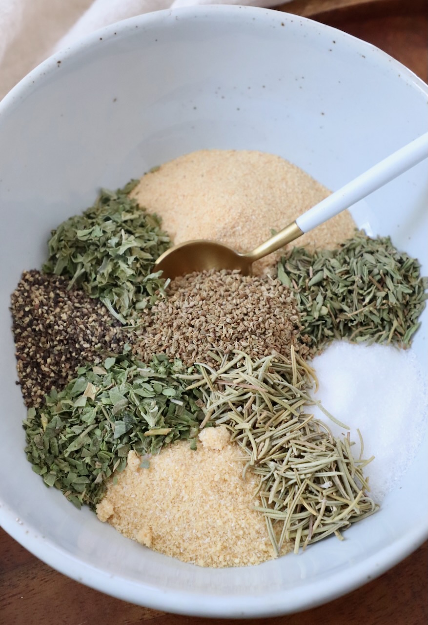 herbs and spices divided in bowl with spoon