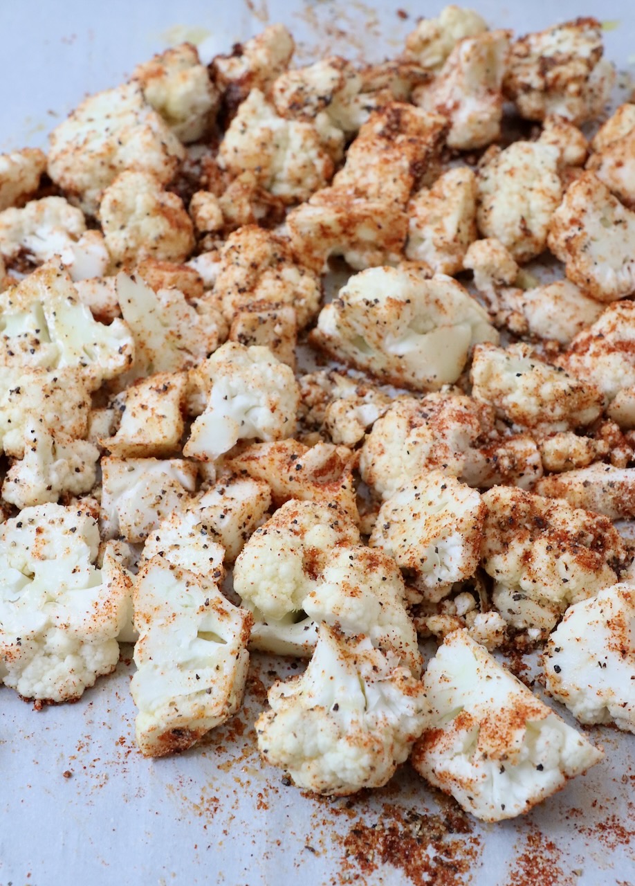 seasoned cauliflower florets on a baking sheet