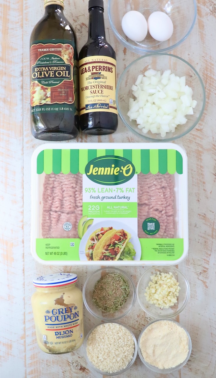 ingredients for turkey meatballs on a white wood board