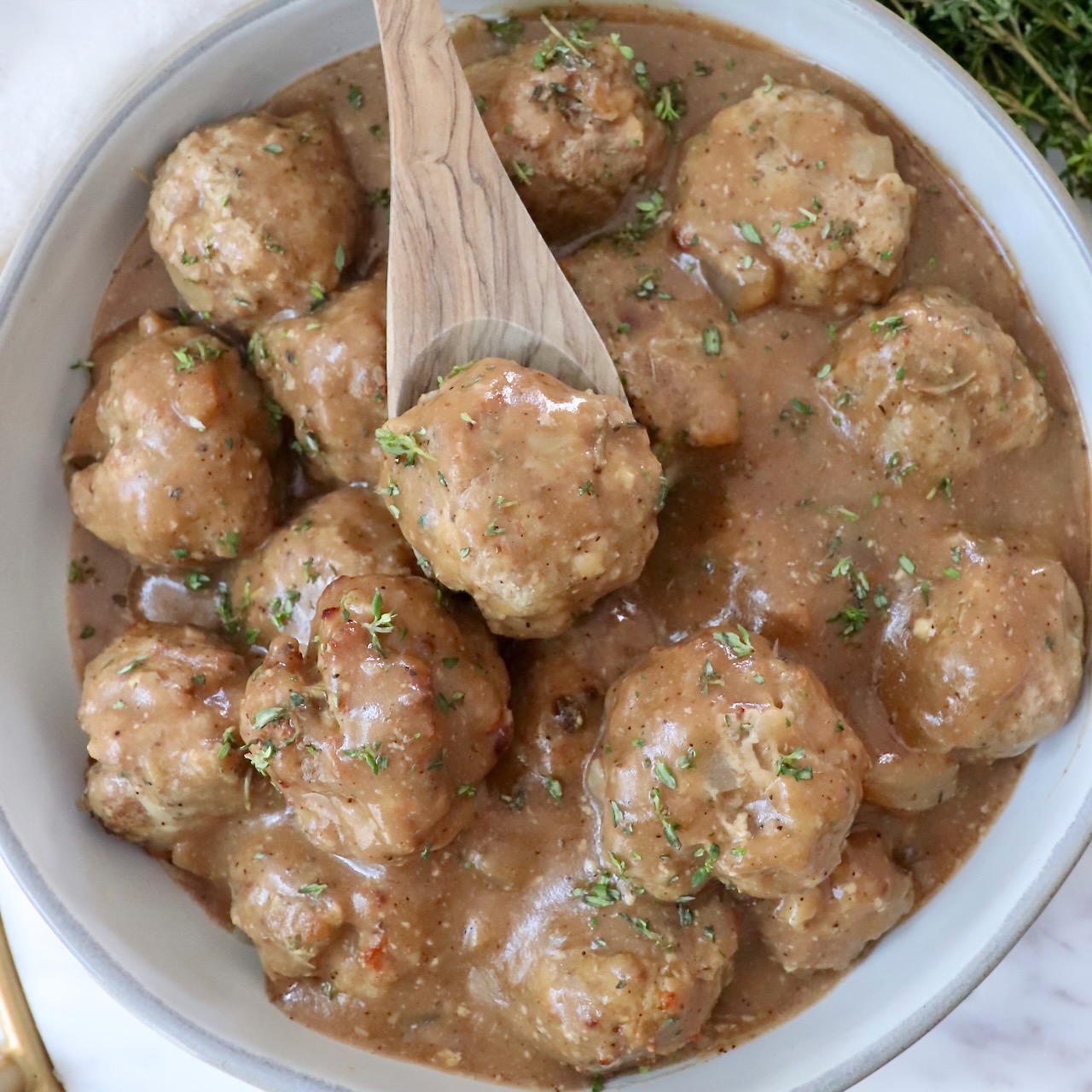 turkey meatballs in gravy in a bowl with a spoon